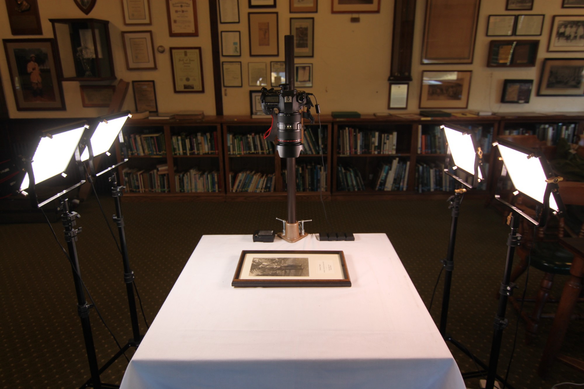 Legendary’s copy stand and lights set up to photograph a framed picture in a club library
